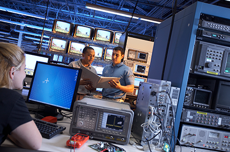 Two male and one female student in computer lab